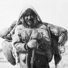 Photograph of an Inuit family travelling overland during summertime at Hudson Bay, Chesterfield Inlet (Igluligaarjuk), Nunavut, 1912 or 1916