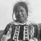Photograph of Miali Aarjuaq wearing a hooded caribou parka, Pond Inlet (Mittimatalik/Tununiq), Nunavut, 1923