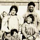 Photograph of a group of Inuit men, women and children from different family groups, Chesterfield Inlet (Igluligaarjuk), Nunavut, summer 1952