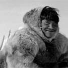 Photograph of an Inuit man, Zachery Itimangnaq, who appears to be working on his sled, at Pelly Bay (Arvilikjuaq), Nunavut, 1953