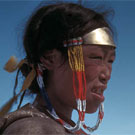 Colour photograph of Inuit woman, Aheamuit, squinting in the sun, Arviat (formerly Eskimo Point), Nunavut, 1937